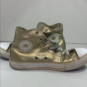 Gold leather converse.